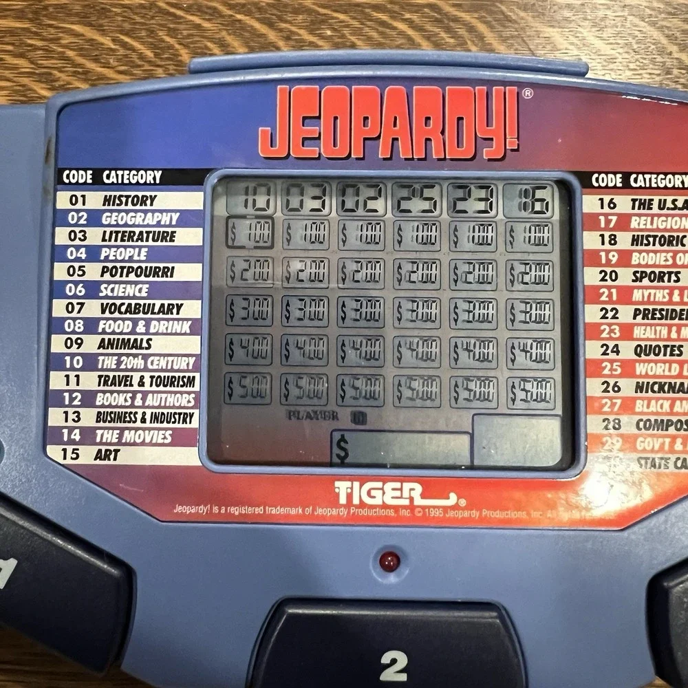 Tiger Electronics Jeopardy Hand Held Game With Cartridge & Answer Question Book